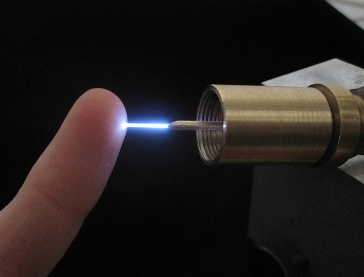 Micro-plasma torch with plasma coming out from the tip of the inner conductor. The plasma is cold enough to be touched bare-handed without damages to the skin.