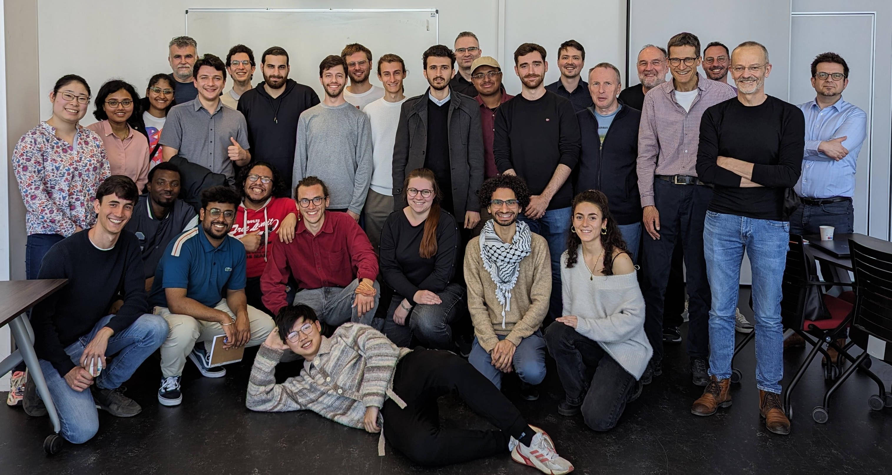 Students and professors pose in meeting room